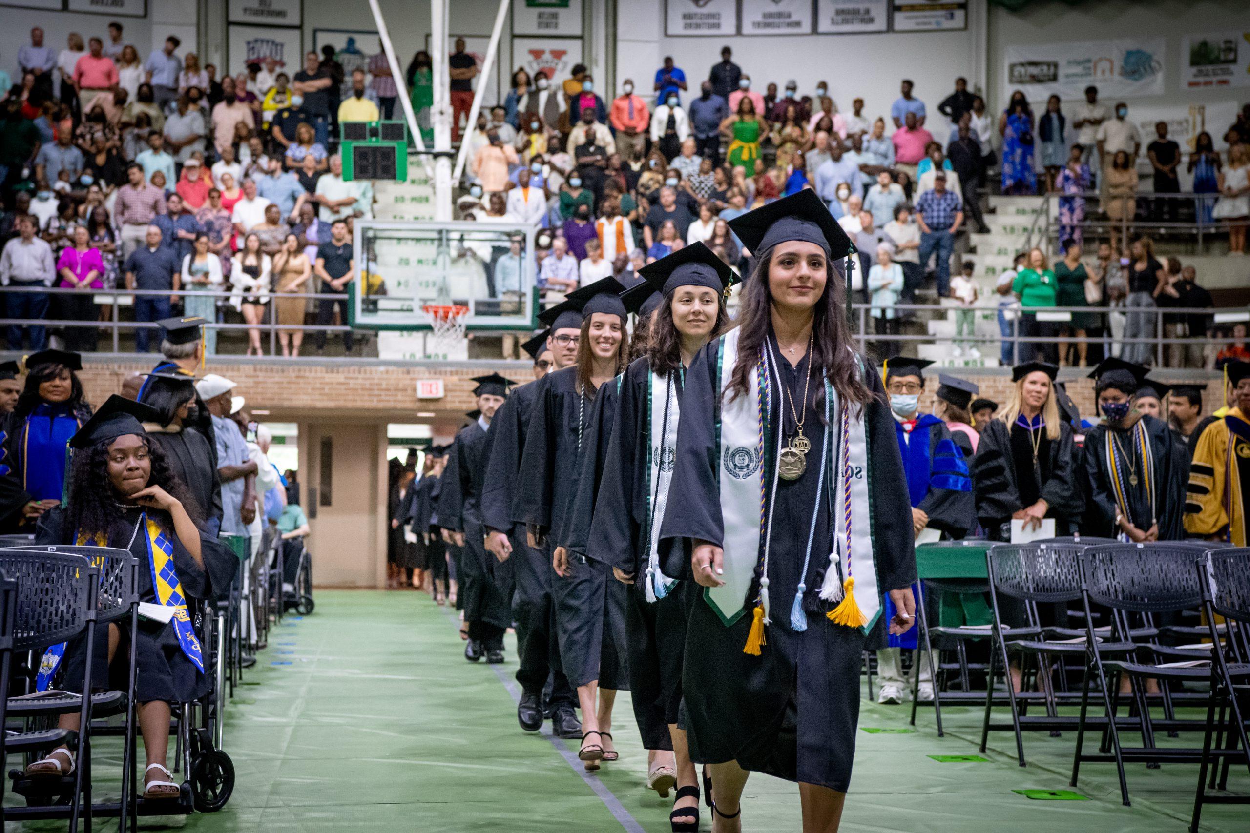 Students entering coliseum for commencement ceremony.