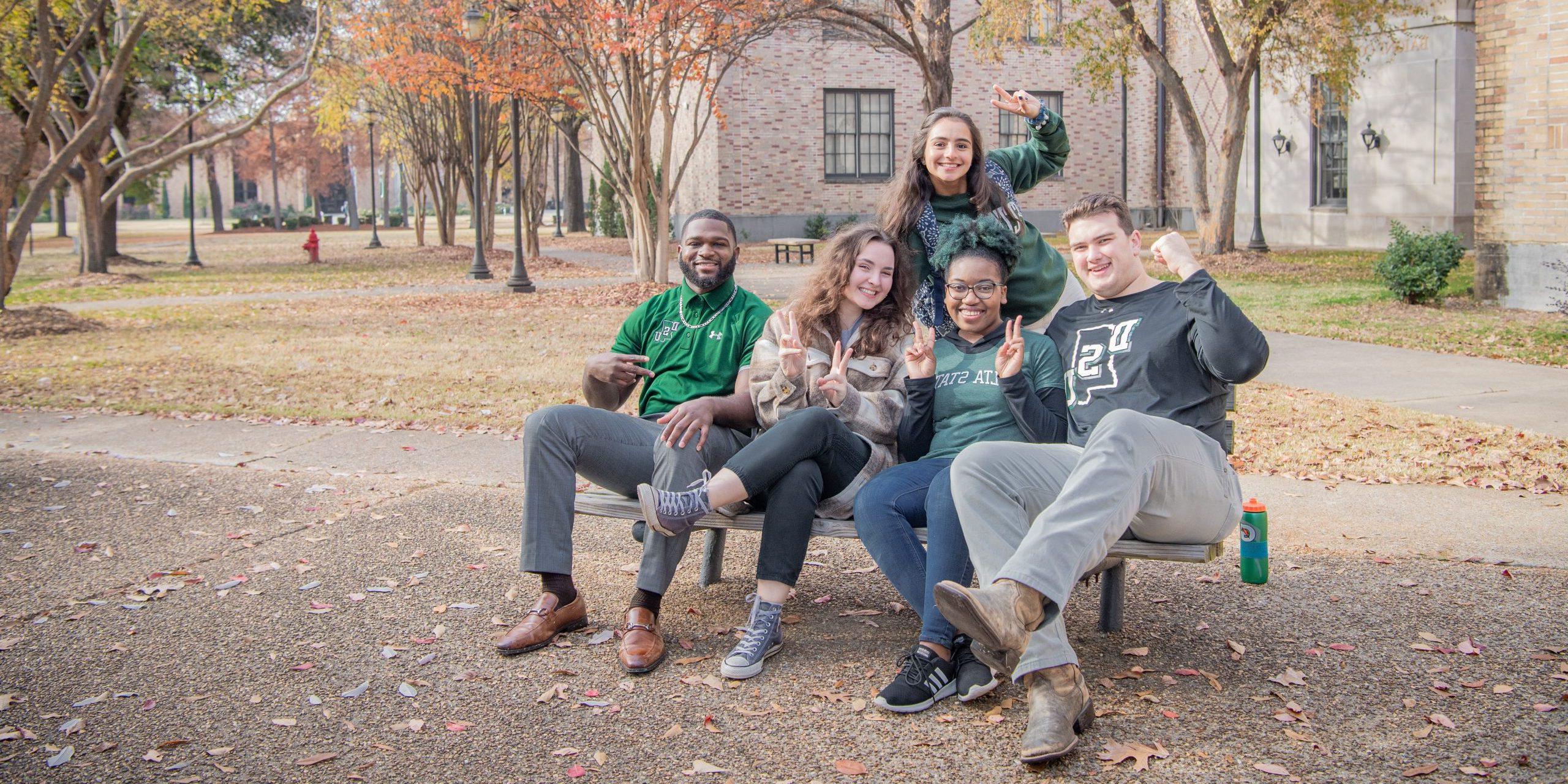 Transfer students hanging out on campus in Delta State gear.